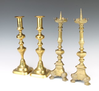 A pair of Victorian brass candlesticks with knopped stems and ejectors 30cm together with a pair of 17th Century style brass pricket candlesticks 32cm 
