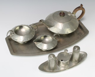 A Craftsmans Art Deco  planished pewter 3 piece condiment comprising salt, mustard, pepper, raised on an associated stand together with a Sillustre planished pewter 3 piece tea service comprising teapot, cream jug and sugar bowl with an associated tray 