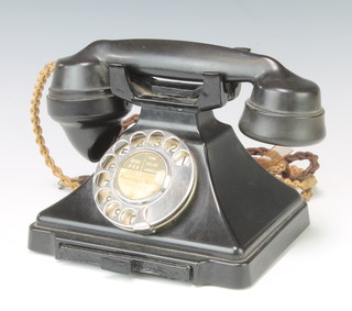 A black Bakelite dial telephone, the base marked 1/232F Tl47/1 