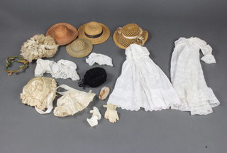 A collection of Victorian and later dolls bonnets, dresses etc 