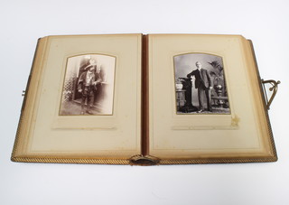 A Victorian leather bound photograph album containing portrait photographs