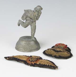 Of Royal Air Force interest,  a Royal Air Force Officer's cap badge, a pair of RAF pilots wings and a pewter model of a running airman 11cm x 5cm x 4cm