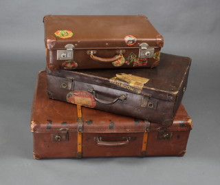 A fibre suitcase with chrome mounts bearing various labels including Raffles Hotel Singapore, Hotel New Yorker, 16cm x 56cm x 34cm and 2 other suitcases 1 with Cunard Line label 18cm x 65cm x 43cm, 1 other with chrome mounts 21cm x 77cm x 57cm  
