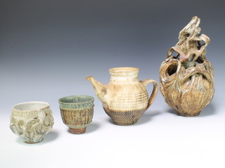 Ray Marshall, a Studio Pottery slip glaze vase 10cm, a cream glazed do. 11cm, a teapot (no lid) and a freeform vase and cover 28cm 