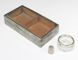 A rectangular silver cigarette box with bevelled glass lid, a table salt and thimble 