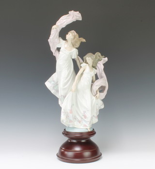 A large Lladro group of 2 ladies with flowing scarves - Allegory of Liberty no. 5819, 52cm, raised on a wooden socle, boxed. 