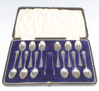 A set of 12 cased silver teaspoons and odd nips London 1928/33, 194 grams 