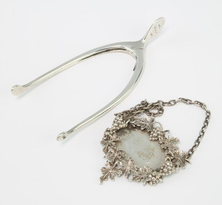 A pair of silver wishbone sugar nips Birmingham 1917 and a silver brandy label London 1962, 46 grams