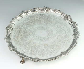 A George III silver salver with chased scroll decoration and fancy border on pad feet London 1763, maker Robert Rugg 1 , 926 grams, 31cm 