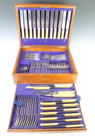 An oak canteen containing a set of silver plated cutlery  
