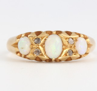 An 18ct yellow gold opal and diamond ring, size N 