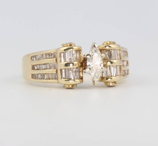 A 14ct yellow gold marquis and tapered baguette diamond ring, size V 1/2