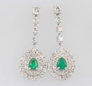 A pair of 18ct white gold pear cut emerald and diamond drop earrings, the centre stone 1.71ct, the brilliant cut diamonds 3.25ct 