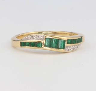 An 18ct yellow gold emerald and diamond ring size L 1/2