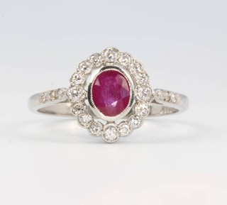 A platinum ruby and diamond cluster ring size P 1/2