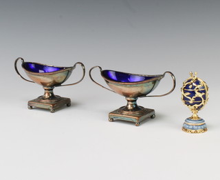 A pair of 19th Century Adam style table salts and a Russian enamelled egg enclosing a palace 