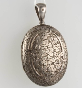 A silver locket with chased decoration 