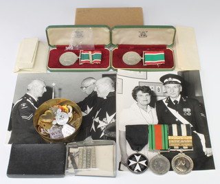 A family group of medals - husband and wife, a group of 3 comprising Most Venerable Order of St John of Jerusalem breast badge of a serving brother, Defence medal, Service medal of The Most Venerable Order of St John of Jerusalem with 3 bars to Private Eric Reginald Lees London SJAB 1953 together with Women's Voluntary Service Long Service Good Conduct medal and bar awarded to Mrs Lees and 1 other Women's Voluntary Service medal, cased, various paperwork including photographs and other minor badges