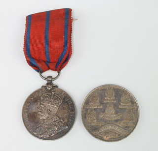 A George V Metropolitan Police Coronation medal to A Sylvester together with a 1977 silver  commemorative crown 

