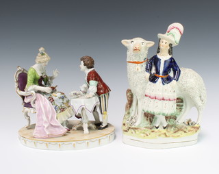 An Italian group of a seated lady and boy at a tea table 19cm and a Staffordshire figure of a lady with giant sheep 22cm 