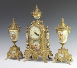 A German gilt metal and enamel 3 piece porcelain clock garniture comprising striking mantel clock surmounted by a lidded urn together with 2 side urns 