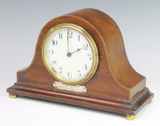 Buren, a Swiss bedroom timepiece with enamelled dial and Arabic numerals contained in an arch shaped inlaid mahogany case 