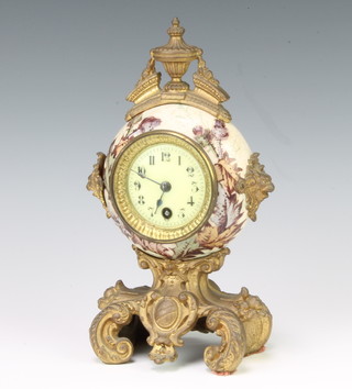 A 19th Century French timepiece with enamelled dial and Arabic numerals contained in a circular porcelain and gilt metal mounted case, raised on a gilt metal shaped base 23cm 