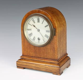 A 19th Century timepiece with painted dial and Roman numerals contained in an oak arch shaped case 