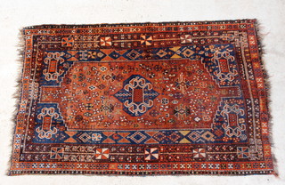 A tan and blue ground Persian Qashqai rug with central medallion within multi row borders 230cm x 150cm