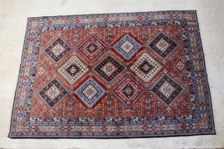 A tan, blue and white ground Yalameh carpet with 11 stylised diamonds to the centre 285cm x 202cm 