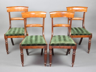A set of 4 Georgian mahogany bar back dining chairs with shaped mid rails and upholstered drop in seats, raised on turned and reeded supports 