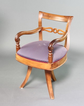 A Biedermeier style bar back open arm desk chair with pierced mid rail and upholstered seat, raised on tripod supports 