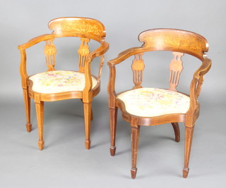 A pair of Edwardian inlaid mahogany tub back chairs with pierced slat backs and Berlin woolwork seats, raised on square tapered supports 