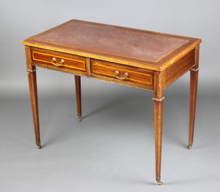 An Edwardian rectangular inlaid mahogany and crossbanded writing table with inset tooled leather writing surface fitted 2 long drawers with brass swan neck drop handles, raised on square tapered supports ending in brass caps and casters 71cm x 90cm x 51cm 