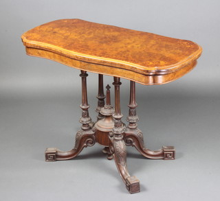 A Victorian shaped inlaid figured walnut card table raised on 4 turned columns and tripod base 71cm h x 94cm w x 47cm d  