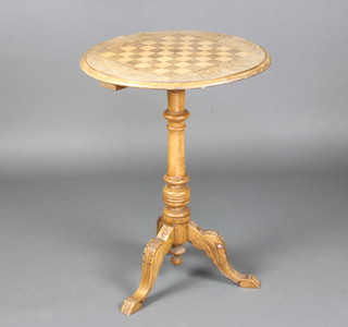 A Victorian circular bleached figured walnut games table raised on a turned column and carved tripod base 71cm x 54cm diam. 