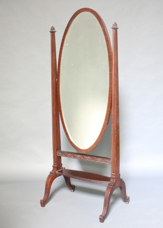 An Edwardian oval bevelled plate cheval mirror contained in a mahogany swing frame 180cm h x 68cm w x 54cm d 