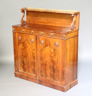 A Regency rosewood chiffonier, the raised back with brass three-quarter gallery, the base fitted a cupboard enclosed by a pair of arched panelled doors, raised on a platform base 107cm h x 96cm w x 38cm d 