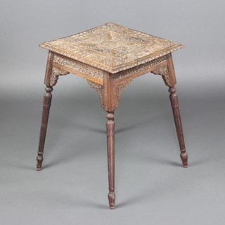 A Victorian anglo-Indian square carved hardwood occasional table decorated pavilions, birds and jackalls, with carved apron and raised on turned supports 61cm h x 46cm w x 44cm d 