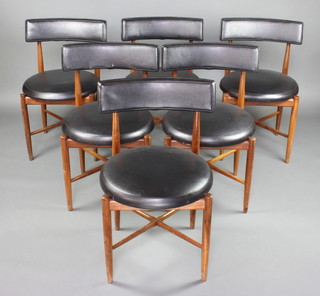 Kofod Larsen, a mid 20th Century set of 6 teak and black rexine dining chairs, raised on turned supports with X framed stretchers 