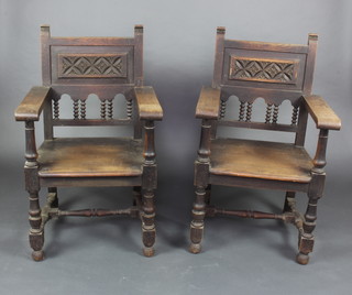 A pair of Victorian carved oak throne style hall chairs with carved backs and solid seats, raised on turned and block supports 