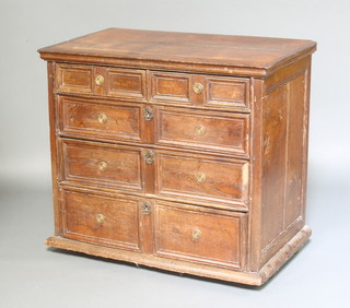 A Jacobean oak chest of 2 short and 3 long drawers with geometric mouldings, raised on bun feet, 86cm h x 94cm w x 54cm d 