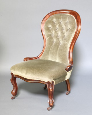 A Victorian mahogany show frame nursing chair upholstered in green buttoned Dralon, raised on cabriole supports 