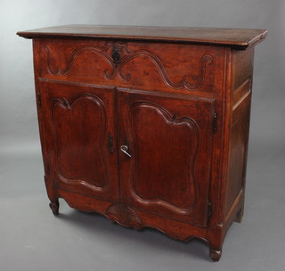 An 18th Century French carved fruitwood side cabinet with hinged lid, the base fitted a cupboard enclosed by a panelled door 114cm x 126cm x 51cm 


