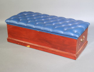 A 19th Century pine ottoman with hinged lid upholstered in blue buttoned dralon with brass drop handles, raised on a platform base 41cm x 132cm x 56cm 
