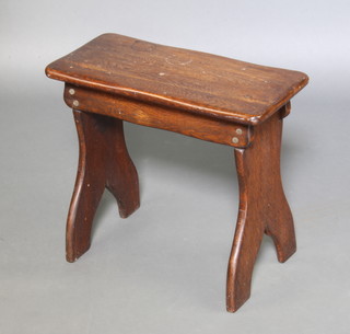 A rectangular oak stool raised on standard end supports 43cm h x 50cm w x 25cm d 