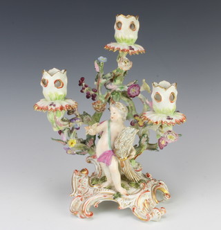 A 19th Century Continental 3 light candelabrum with a putti before a bocage decorated tree, raised on a rococo base 27cm 