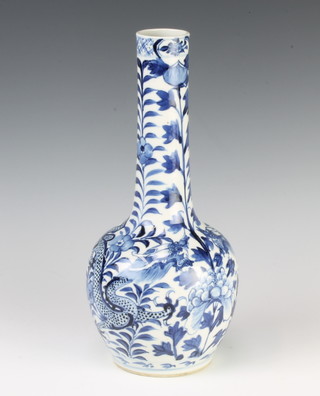 An 18th Century style Chinese blue and white bottle vase decorated with dragons amongst flowers with a four character mark to base 29cm 