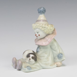 A Lladro figure of a clown with a puppy on its lap 5277 12cm 