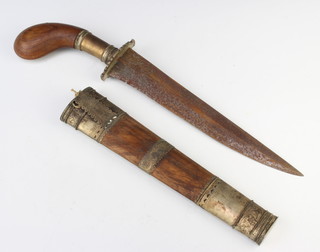 An Eastern dagger with 26cm engraved blade with pistol grip, contained in a hardwood and white metal mounted scabbard